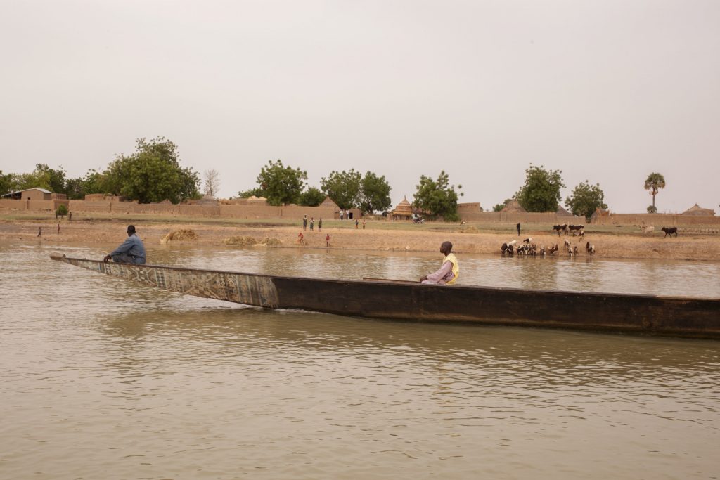 Zakari Soumana, a vaccinator at the Centre for Integrated Health Programs (CIHP) in Ouna, Dosso District, travels aboard a motorboat with a batch of polio vaccines on the Niger river to the village of Bongnani, Niger, Tuesday, 12 April, 2016. Soumana is to administer polio vaccines to the children in Bongnani, part of an effort to vaccinate all children against the virus.
Niger is no longer poliovirus-infected, according to the Global Polio Eradication Initiative, but remains at high risk of outbreaks. Detection of wild poliovirus type 1 (WPV1) in 2016 in north-eastern Nigeria means the entire region is currently at risk. Niger, along with other countries of the Lake Chad sub-region, declared the outbreak to be a regional public health emergency and is implementing a regional outbreak response, coordinated with neighbouring countries.
Polio is spread through person-to-person contact. When a child is infected with wild poliovirus, the virus enters the body through the mouth and multiplies in the intestine. It is then shed into the environment through the faeces where it can spread rapidly through a community, especially in situations of poor hygiene and sanitation. If a sufficient number of children are fully immunized against polio, the virus is unable to find susceptible children to infect, and dies out.
In Niger, the majority of the population lives far from health facilities. In order to provide health services to people living in the most remote areas, health outreach programs are organized. Health workers travel to designated villages to perform vaccinations and prenatal checkups. Villages situated within a 17-kilometre radius are informed of these events in order for mothers and children to travel to the site on the scheduled day. This strategy has increased the vaccination coverage in many areas. UNICEF/UN026544/Parry