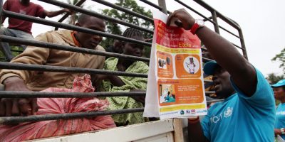 Movement of people from one area to another has resulted in the spread of Ebola in Liberia. On 25 April, 2014, this outreach worker explains to a group of travelers leaving Voinjama on a truck, alert symptoms of Ebola to watch out for and report immediately.
In April 2014 in Liberia, UNICEF workers share information on the symptoms of Ebola virus disease (EVD) and best practices to help prevent its spread in Lofa County, including posters bearing information on and illustrations of such practices. As of 27 July 2014, a total of 1,323 cases, including 729 deaths, had been attributed to EVD in the four West African countries of Guinea, Liberia, Nigeria and Sierra Leone. Liberia has borne 329 of these cases (100 confirmed, 128 probable and 101 suspected), including 156 deaths. UNICEF/UNI167518/Jallanzo