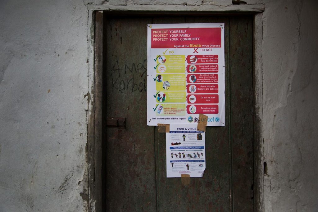 On 29 August in Liberia, a large poster, among those being distributed by UNICEF, is affixed to a door in Dolos Town in Margibi County. The poster bears information and illustrations on the symptoms of EVD and best practices to help prevent its spread. Such preventative practices include washing ones hands with soap and clean water; visiting a health clinic if one experiences a headache, fever, vomiting, pain, diarrhoea, red eyes or a rash; and avoiding risky behaviours such as touching people who have signs of the disease. The poster bears the UNICEF logo.
The worst outbreak of Ebola virus disease (EVD) in history continues to ravage communities in West Africa. UNICEF estimates that 8.5 million children and young people under the age of 20 live in areas affected by EVD in Guinea, Sierra Leone and Liberia, countries where disease transmission is widespread and intense. Of these, 2.5 million are under the age of 5. Preliminary UNICEF estimates also indicate that at least 3,700 children in Guinea, Liberia and Sierra Leone have lost one or both parents to EVD since the start of the outbreak. Nigeria and Senegal are also affected, having experienced an initial case or cases, or localized transmission. UNICEF remains at the forefront of efforts to respond to and help curtail the outbreak. In Guinea, UNICEF has been distributing bars of soap, bottles of chlorine for handwashing and household water treatment, and flyers with information on EVD; preventative practices have also been shared through a door-to-door campaign supported by UNICEF and partners. In Liberia, UNICEFs partners, in co-ordination with the Ministry of Health and Social Welfare and the United States Agency for International Development (USAID), are distributing household protection kits in the hardest-hit areas. The kits contains critical supplies protective gowns, gloves and masks, as well as soap, chlorine and a sprayer, along with instructions on the use and safe disposal of materials UNICEF/UNI172225/Kesner