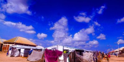 Des structures improvisées et des tentes côtoient des bâtiments de plain-pied dans un camp de personnes déplacées dans le nord-est du Nigeria.